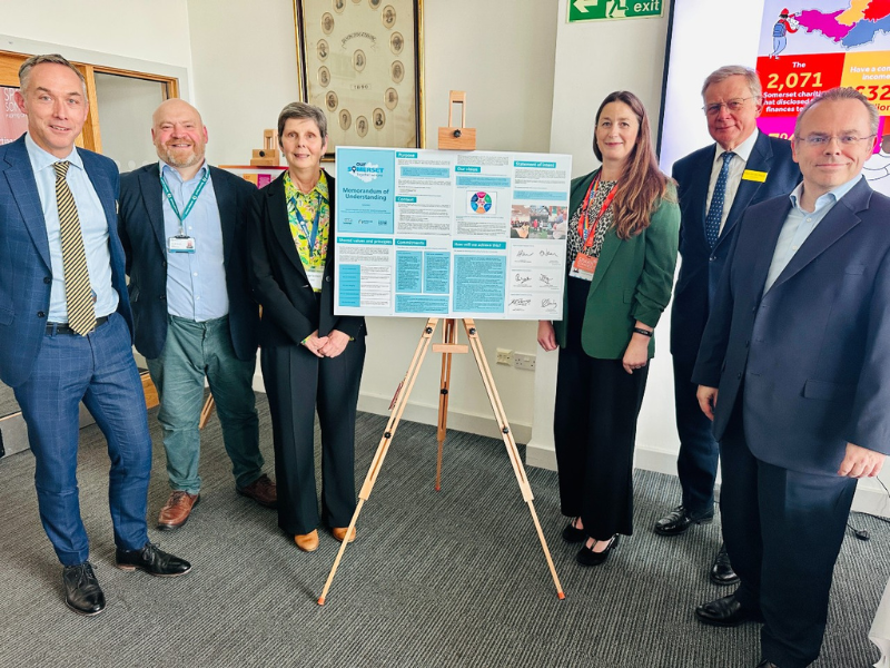 Team of people standing next to a flip chart