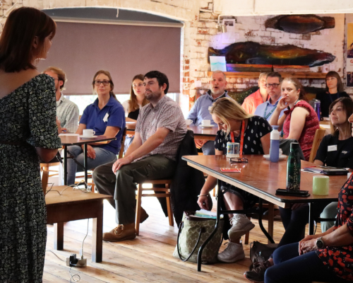 Photograph of a Volunteer Coordintaors' Forum, speaker presenting to a room full of attendees.