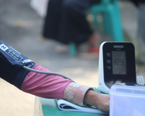 Photograph of a person's arm while they are having their blood pressure tested.